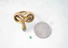 Tiny Jadeite cabochon next to a snake ring.