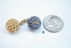 Photo showing the finished tiny Sapphire next to the cufflink that it will be mounted into.