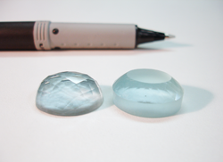 Photo of an Aquamarine finished stone and one that is half finished.