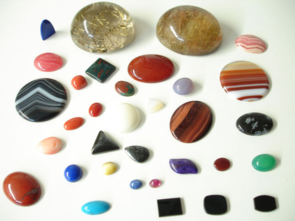 Photo of cabochons of various sizes, colors, and shapes.