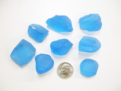 Several pieces of rough blue Topaz material.