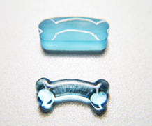 The shape of a dog bone carved from blue Topaz.