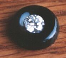 A round blakc onyx with a diamond in the middle