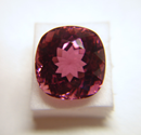 Picture of a cushion pink Tourmaline which is windowed.