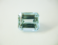 Shows the emerald cut Aquamarine before re-faceting.