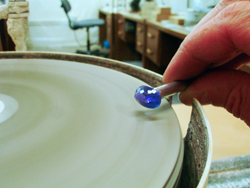 Shows me shaping the Tanzanite on my faceting machine by hand.