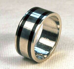 A platinum ring band inlaid 360° with 2 Black Jade inlays.