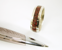 A wedding band inlaid 360 degrees with petrified dinosaur bone.