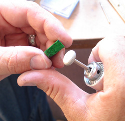 Denton, the cutter, carving a piece of Jadeite to fit it in the ring.