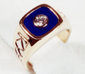 Photo of a signet style ring with diamond in the middle of a Lapis inlay.