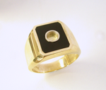 Photo of a ring with a round hole in the middle of the black Jade inlay.