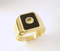 Photo of the ring with the emerald cut Black Jade and round tube in the middle.