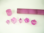 Small photo of 5 pink synthetic sapphires which we faceted into geometric shapes.