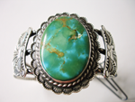 A Turquoise cabochon which is broken and needs to be repaired.