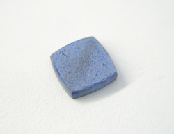 Photo of a square flat Lapis cabochon which has a whiteish surface because it was etched by acid.