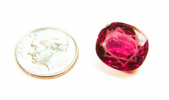 A Rhodolite gemstone that is all scratched.