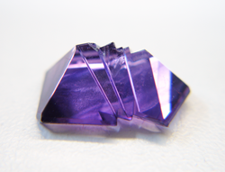 A purple Amethyst fantasy cut with a chip on the bottom which needs to be repaired.