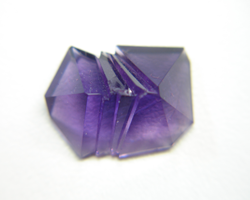Another view of the bottom of the fantasy cut Amethyst showing the chip which needs to be repaired.
