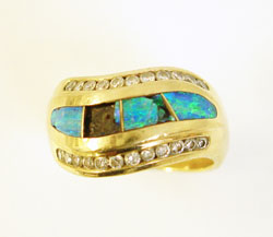 Photo of a 14 karat gold ring with 2 broken Opal inlays.