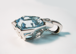 Photo of the white gold pendant with a Blue Topaz set in it.