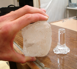 I am holding the piece of rough Quartz next the broken cane handle to see if it is large enough to used to carve a new cane handle.