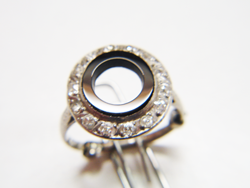 Photo of an antique Diamond ring with a round black Onyx which is broken.