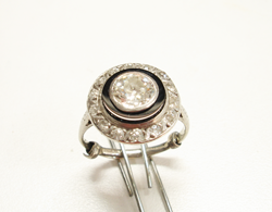 Photo of an antique Diamond ring with a new round black Onyx which has a large hole drilled in the center.