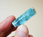 I am holding an Aquamarine crystal from Mount Antero in Colorado in my fingers.