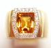 Photo of a yellow gem in a ring.