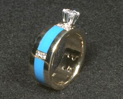 Engagement ring inlaid with several pieces of plain blue Sleeping Beauty Turquoise on the sides.