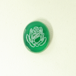 Photo of an oval green Onyx stone with the image of a flower which was made with a laser.