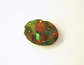 A black opal which is chipped and needs to be repaired.