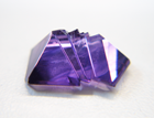 Photo of a purple Amethyst fantasy cut which is chipped and needs to be repaired.