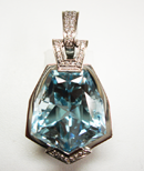 Photo of a blue Topaz gemstone in a pendant mounting which has a chip which needs to be repaired.