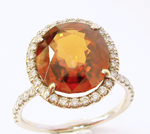 Picture of an orange Spessartite garnet in a ring which needs the table repolished.