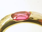 A pink Spinel with a chip which is set in a ring